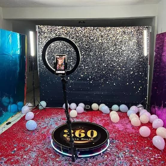 360 photo booth platform surrounded by balloon styling at a party