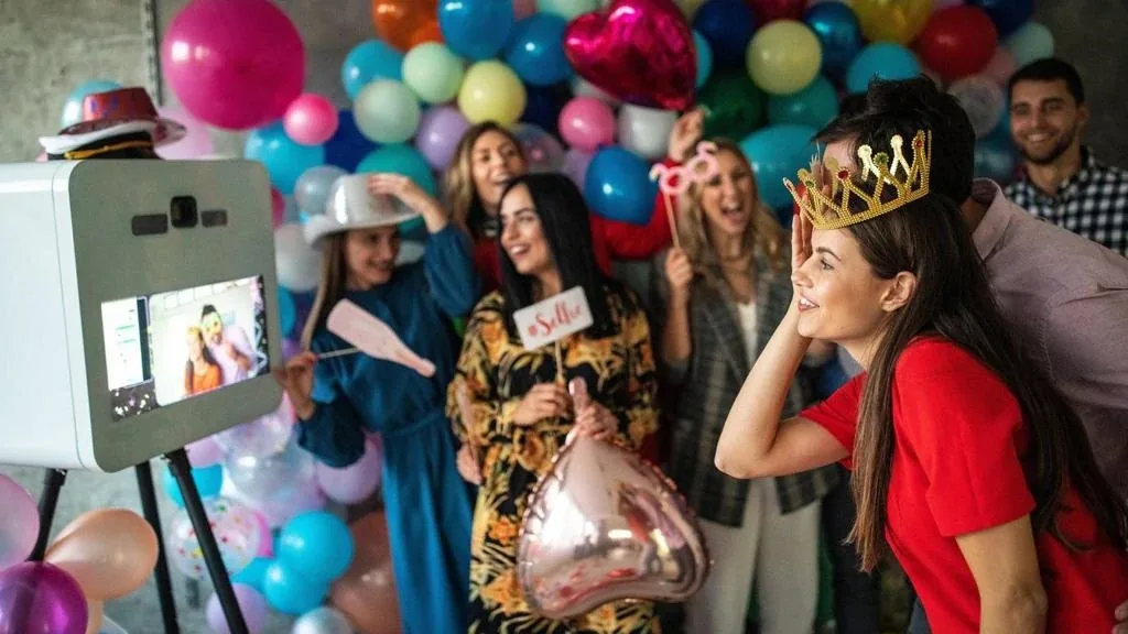 Birthday party photo booth surrounded by balloon styling