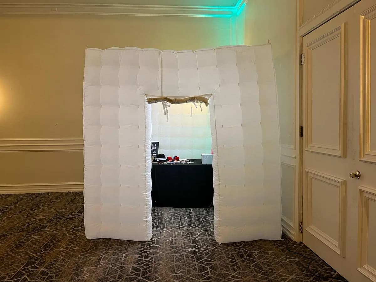Inflatable LED photo booth enclosure set up at an indoor venue