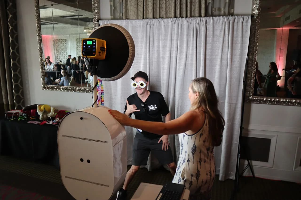 Open air photo booth with ring light beside a balloon arch backdrop at a Chicago event