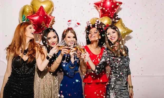 Group of guests posing with confetti in an open air photo booth