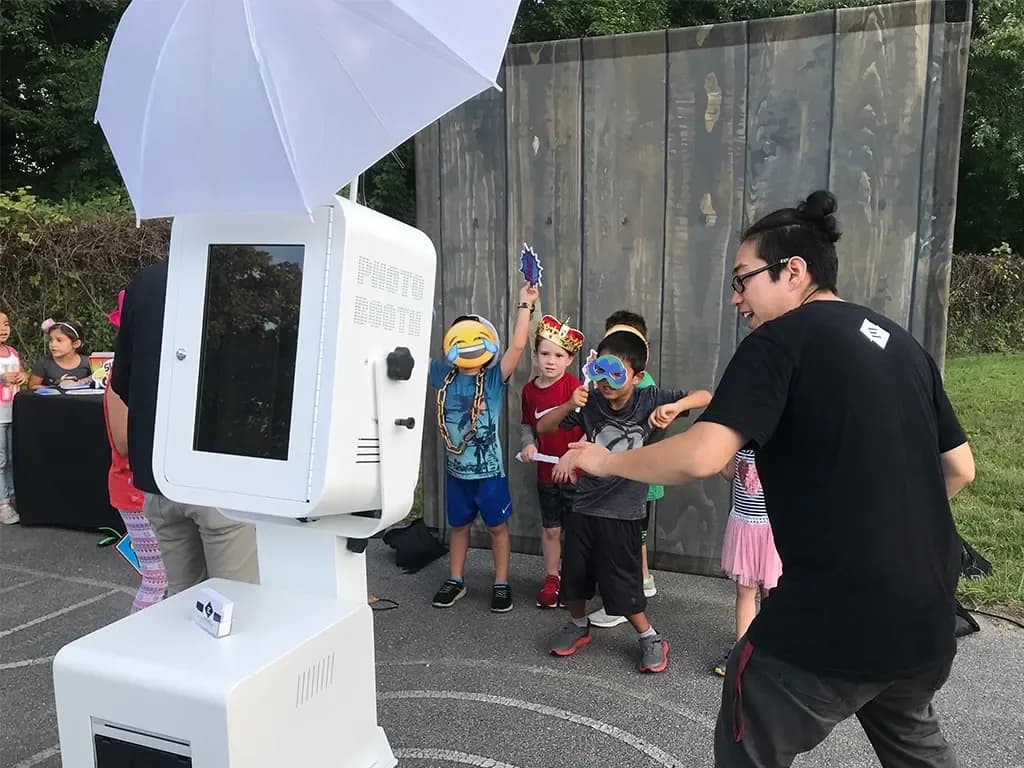 Guests posing with balloons at an open air photo booth