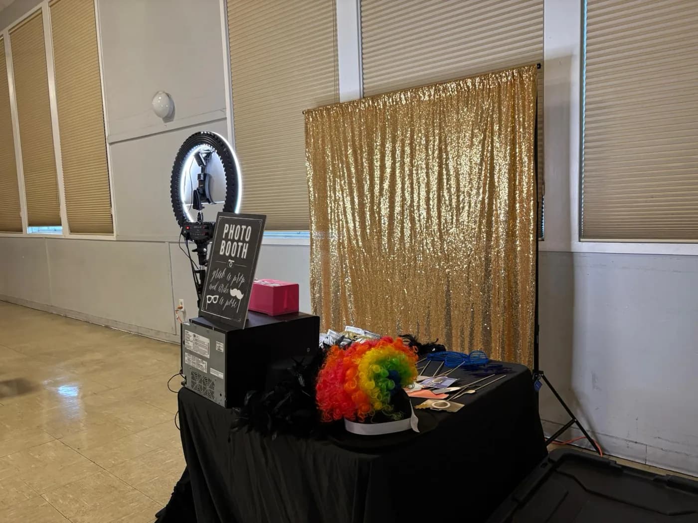 Photo booth attendant setting up equipment at an event venue