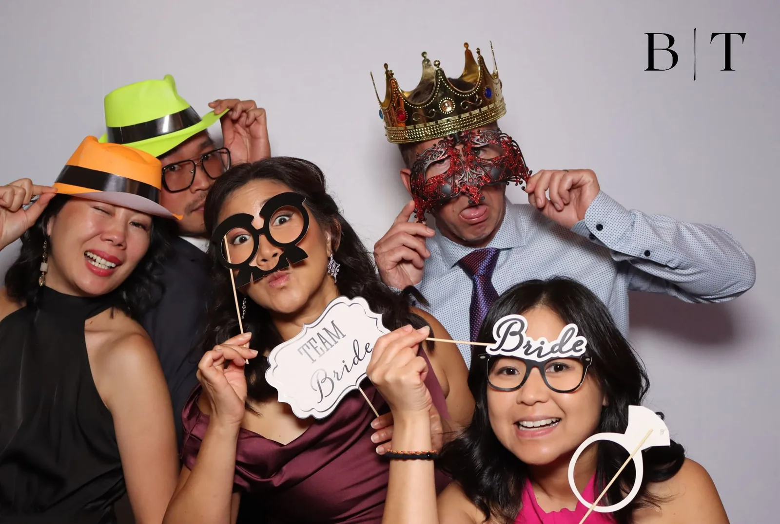 Group of guests in costume props at an event photo booth