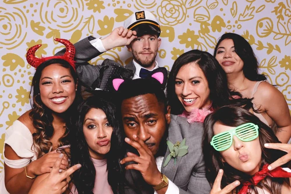 Group of guests holding photo booth props during a portrait session