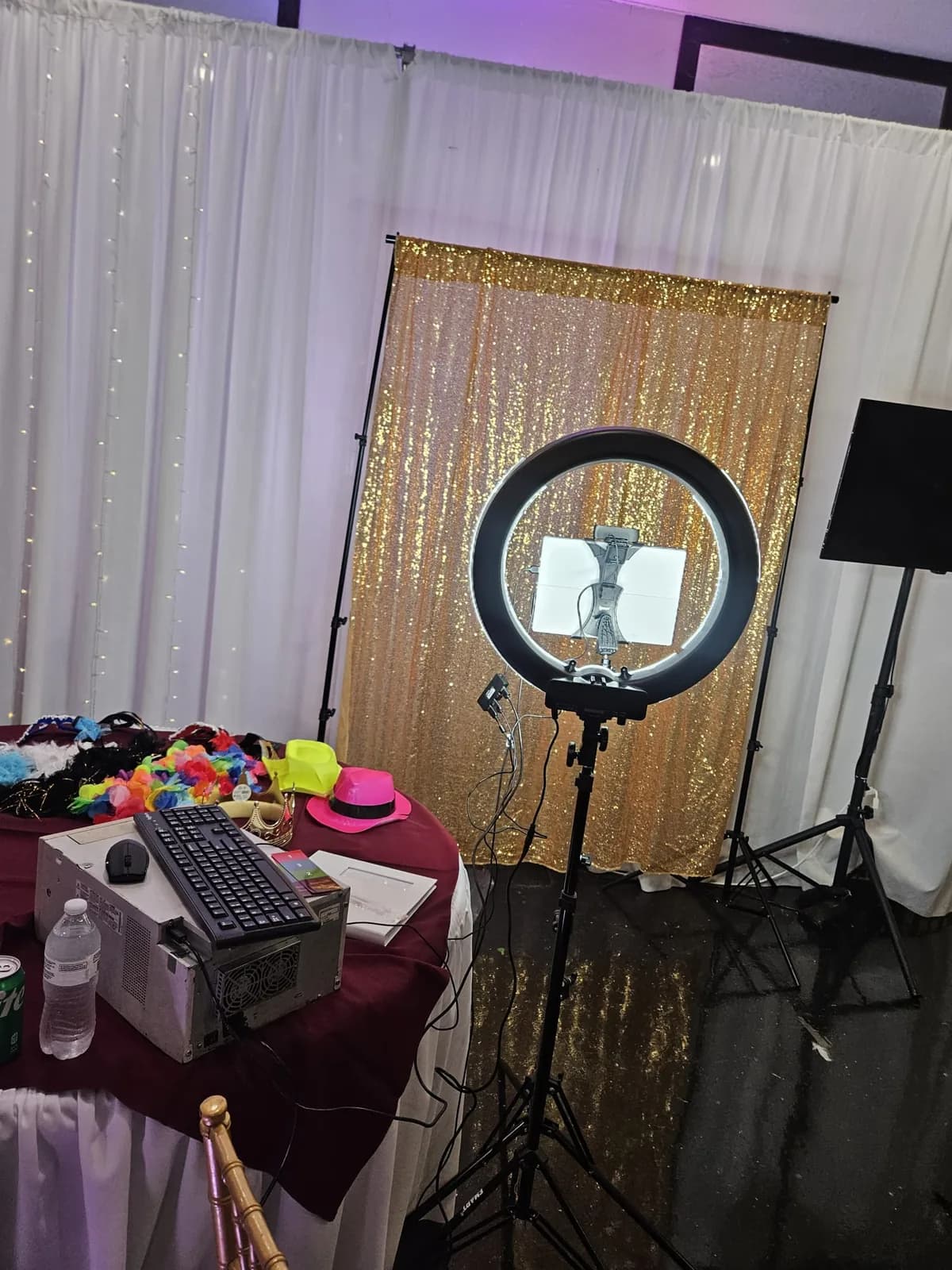 Photo booth ring light and styled prop table at an event venue